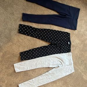 Three pairs of size 7/8 pants leggings from various stores.
